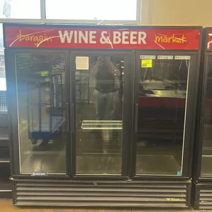 True GDM-72 3-door glass door refrigerated merchandiser. Features a self-contained refrigeration system, black exterior, illuminated top marquee, and 