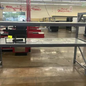 Two-tier metal teardrop racking unit. Features teardrop uprights, step beams, and solid metal decking. Dimensions: 108"L x 37"W x 73"H. Contents not i