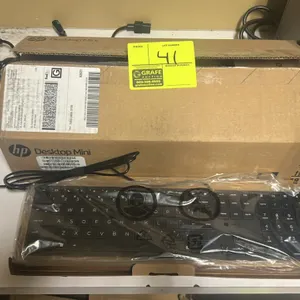 HP wired keyboard. Features a black finish and a full layout with numeric keypad. Includes HP Desktop Mini packaging.