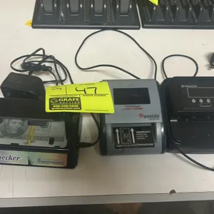 Lot of 3 electronic counterfeit detectors. Includes an Angstrom MoneyChecker, a Cassida InstaCheck automatic detector, and a Carnation counterfeit det