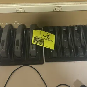 Carttronics caster reset controller set. Includes (4) handheld controllers and (2) 4-slot charging decks with power cords.