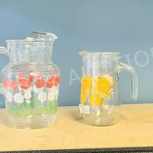 2 vintage glass juice jugs