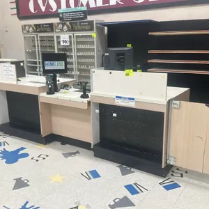 Laminate customer service counter. Features modular multi-unit construction with a light wood-grain laminate finish, integrated front black pegboard d