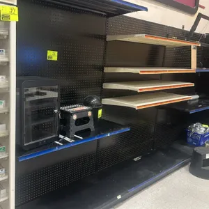 12'L of Lozier wall shelving. Features black pegboard backing, 19"D base shelves, and adjustable upper shelves. Unit measures 74"H. Contents and acces