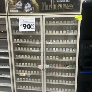 Lockable 2-door tobacco merchandiser cabinet. Features two glass doors, internal adjustable shelving with product dividers, and a Marlboro branded top