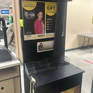 Western Union branded laminate service kiosk. Features an upper advertising header, integrated clear acrylic brochure holders, a black counter writing