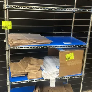 Assorted retail packaging supply lot. Includes a quantity of brown kraft paper bags in various sizes and white plastic poly t-shirt bags. Note: Wire s