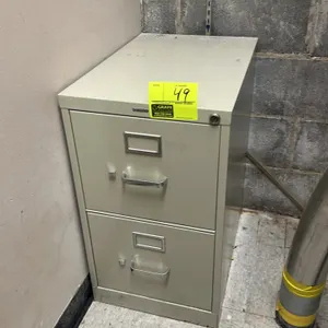 HON metal 2-drawer vertical filing cabinet. Features tan finish, aluminum-tone pull handles, and integrated label holders. Equipped with a key lock. N
