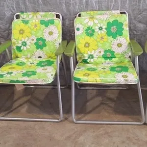 Vintage aluminum folding chair features a