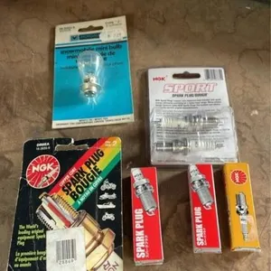 Assorted spark plugs and snowmobile mini bulb