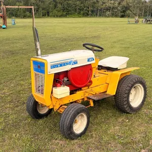 OFFSITE - 1 1/2 international stationary motor mounted in old cub cadet tractor