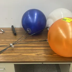 Reusable balloon-style decorative cluster. Features three colored plastic globes in blue, white, and orange mounted on flexible black poles gathered b