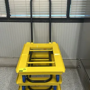 National Cart TD-3224-2-TL steel tote dolly. Features a yellow powder-coated steel frame, open center design, and a black tubular push handle. 34"x25"