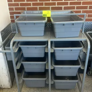 Metal mobile tub rack cart. Features a gray-painted metal frame with built-in slide tracks and a top shelf. Includes gray poly bus tubs. Equipped with