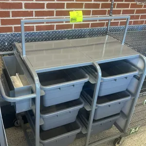 Metal mobile tub rack cart. Features slots for poly bus tubs and a side-mounted storage bin. Includes 6 gray plastic bus tubs. Mounted on casters. 26"