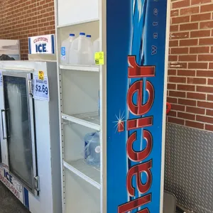 Glacier metal multi-tier merchandiser display rack. Features white metal frame construction, Glacier Water branded side graphic panels, three wire she