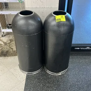 Circular domed trash bin. Features a textured dark gray finish, open dome top with silver-tone trim, and a protective silver-tone base rim. Designed f
