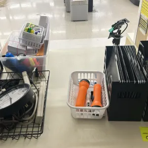Assorted office supplies and desk accessories. Includes a Sterling & Noble wall clock, two black poly file organizers with labeled tabs, two power str