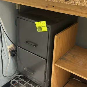 Metal 2-drawer vertical filing cabinet. Features two drawers with pull handles and a gray finish. Note: Wire riser, desk, computer, and all other back