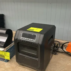 Comfort Zone personal infrared room heater. Features a front heating grille, a top digital display with control buttons, and integrated side carrying 