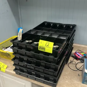 Poly cash till. Features molded black plastic construction with multiple bill and coin compartments, and spring-loaded bill clips. Note: Bill clips ma