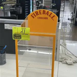 A Fireball Cinnamon Tabletop Merchandiser. (Fireball, Recent) An acrylic countertop display case designed to showcase Fireball Cinnamon Whiskey. Featu