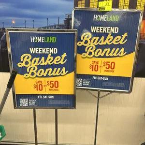 Assorted metal sign stands. Includes one dual-upright chrome-finished stand with a flat square base and one single-pole chrome-finished stand with a w