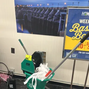 SIR poly mop bucket with mop. Features a green polyethylene bucket with a manual wringer attachment. Mounted on four swivel casters. Includes a metal 
