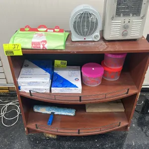 Laminate display shelving unit. Features a wood-grain finish, a flat top, and two curved lower shelves with wire retaining rails. 3'L. Contents and ap