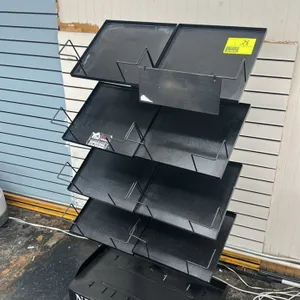 Unbranded metal multi-tier portable newspaper merchandiser. Features four tiers with eight total display shelves, metal wire retainer brackets, and "N