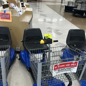 Mart Cart electric rideable grocery cart. Features a blue plastic body shroud, front wire cargo basket, black seat, and an integrated battery charger 