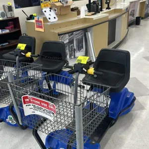 Mart Cart electric rideable grocery cart. Features a blue plastic body, front wire-mesh shopping basket, black seat, and handlebar controls. Equipped 