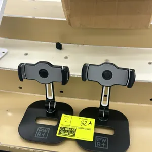Pwr+ tablet holder stand. Features an adjustable spring-loaded clamp, an articulating support neck, and a weighted metal base with a cutout handle. De