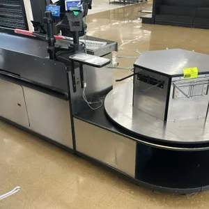 Check lane counter. Features an 11'L frame with a 4'L conveyor belt and a rotating bagger stand with a stainless steel laminate top. Note: POS system,