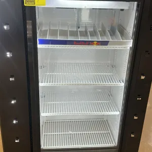 True GDM-10SSL-HC~TSL01 single glass door beverage cooler. Features three wire shelves, one Red Bull branded organizing rack, and LED lighting. Self-c