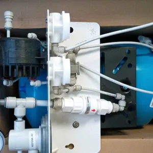 3M reverse osmosis water filtration system. Features a blue storage tank, mounting bracket with integrated pressure gauge, permeate pump, Flojet regul