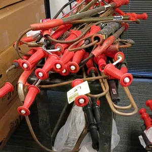 Assorted plumbing lot including multiple toilet and urinal augers. Brands include Ridgid and Husky. Includes one black plastic two-shelf utility servi