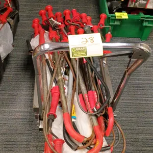 Assorted toilet augers and a mobile hydraulic lift cart. Includes multiple RIDGID and assorted brand closet/toilet augers with red vinyl handles. Plat