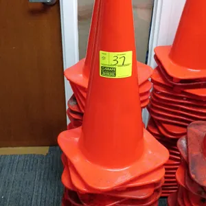 Orange PVC safety traffic cone. Features a square base and stackable design. Engineered for traffic control, construction zones, and parking safety.