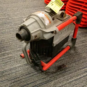 RIDGID K-60SP compact sectional drain cleaning machine. Features a portable tubular frame, clutch lever, and forward/reverse switch. Electrical: 115V,