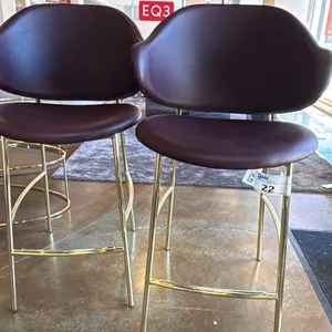 PAIR OF CALLIGARIS BRASS AND LEATHER HOLLY STOOLS. SOFTER BURGUNDY. NICELY DESIGNED AND COMFORTABLE.