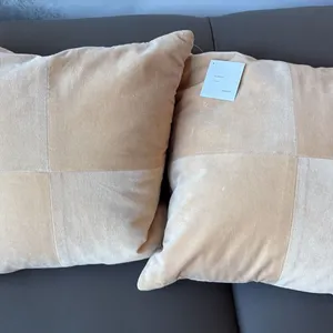 PAIR OF BETTINA EILERSEN BEIGE THROW CUSHIONS. RETAIL $310