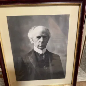 Black and white photo of John A. MacDonald - Canada's first Prime Minister presented in a wooden fra