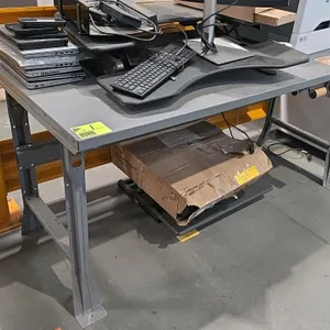 Metal industrial desk featuring gray steel construction and an under-mount roll dispenser rod. Dimensions: 6' x 2½' x 2' 10". Note: Desk only; all ele
