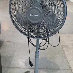Lasko 3-speed oscillating pedestal fan. Features a height-adjustable stand, plastic grill and blades, and integrated controls on the motor housing. Mo