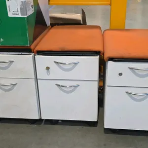 Steelcase mobile cushioned 2-drawer file cabinet. Features light gray metal construction with an orange fabric cushioned top. Equipped with one box dr