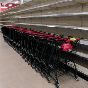 Metal wire shopping cart. Features a black powder-coated finish, red plastic handle with Grocery Outlet branding, a red plastic child seat with safety
