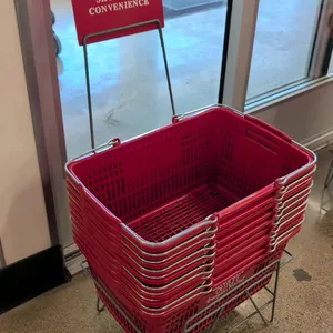 Red poly shopping baskets with metal stand. Includes (10) 19"L red plastic shopping baskets with dual folding metal wire handles and branded graphics.