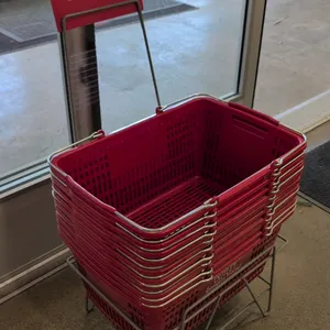 Set of 19" poly shopping baskets with a metal stand. Features red plastic construction with dual metal wire carrying handles and Grocery Outlet brandi