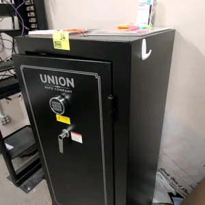 Union Safe Company metal safe. Features electronic keypad combination lock, carpeted interior with adjustable shelves, three active locking bolts, and